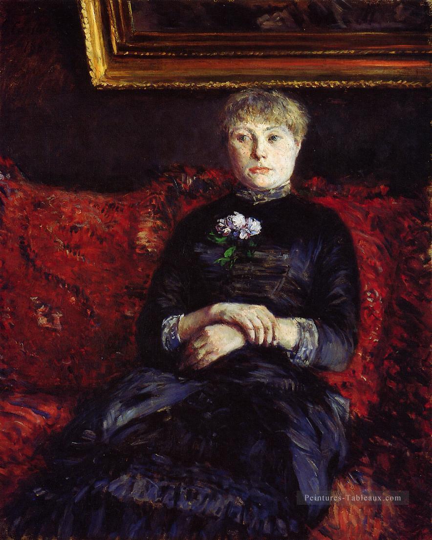 Femme assise sur un canapé à fleurs rouges Gustave Caillebotte Peintures à l'huile